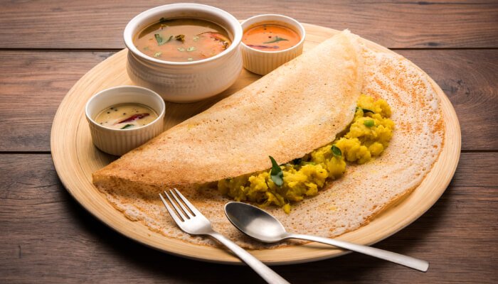 Crispy golden masala dosa with potato filling and chutney