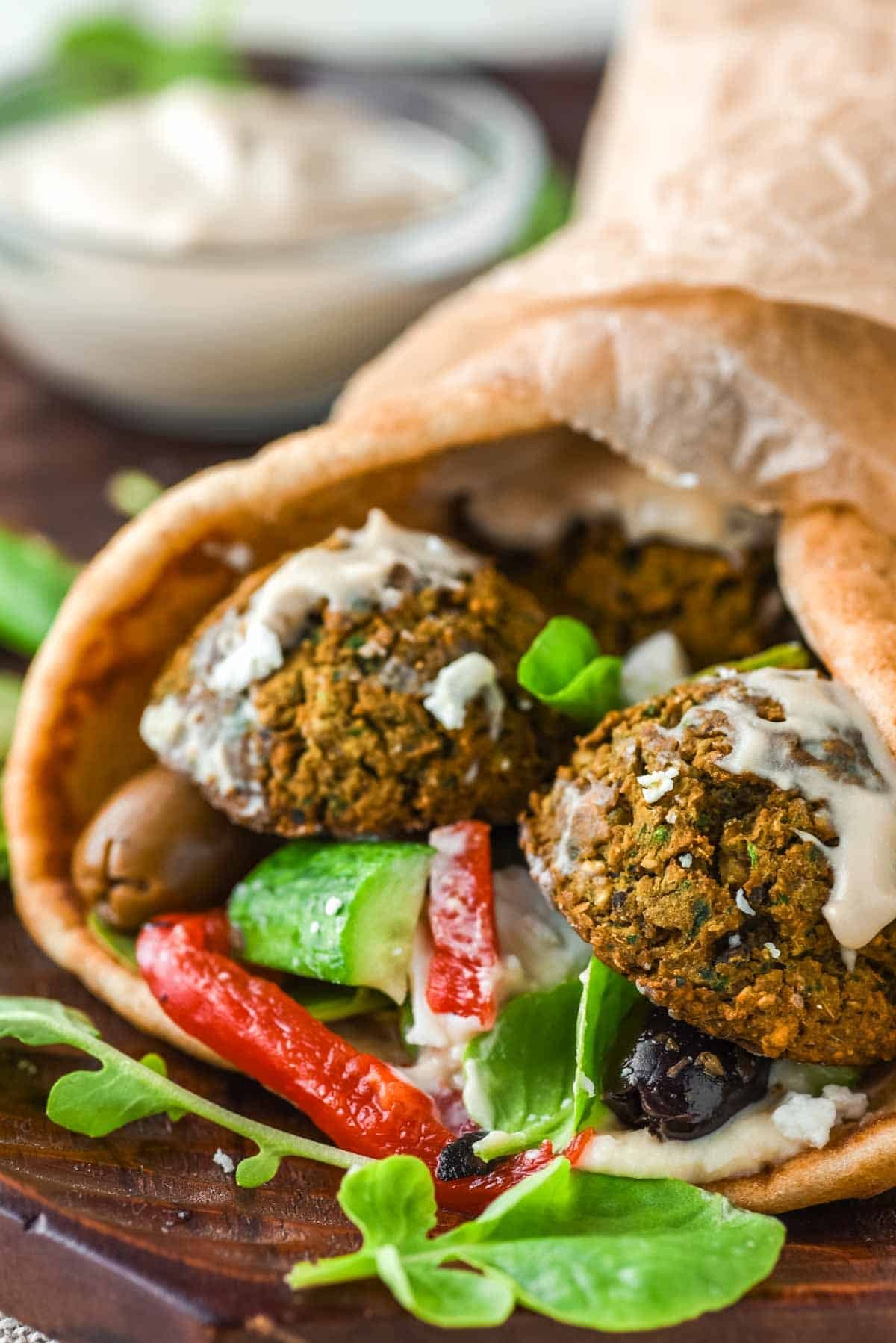 Falafel wrap in pita with salad and tahini sauce