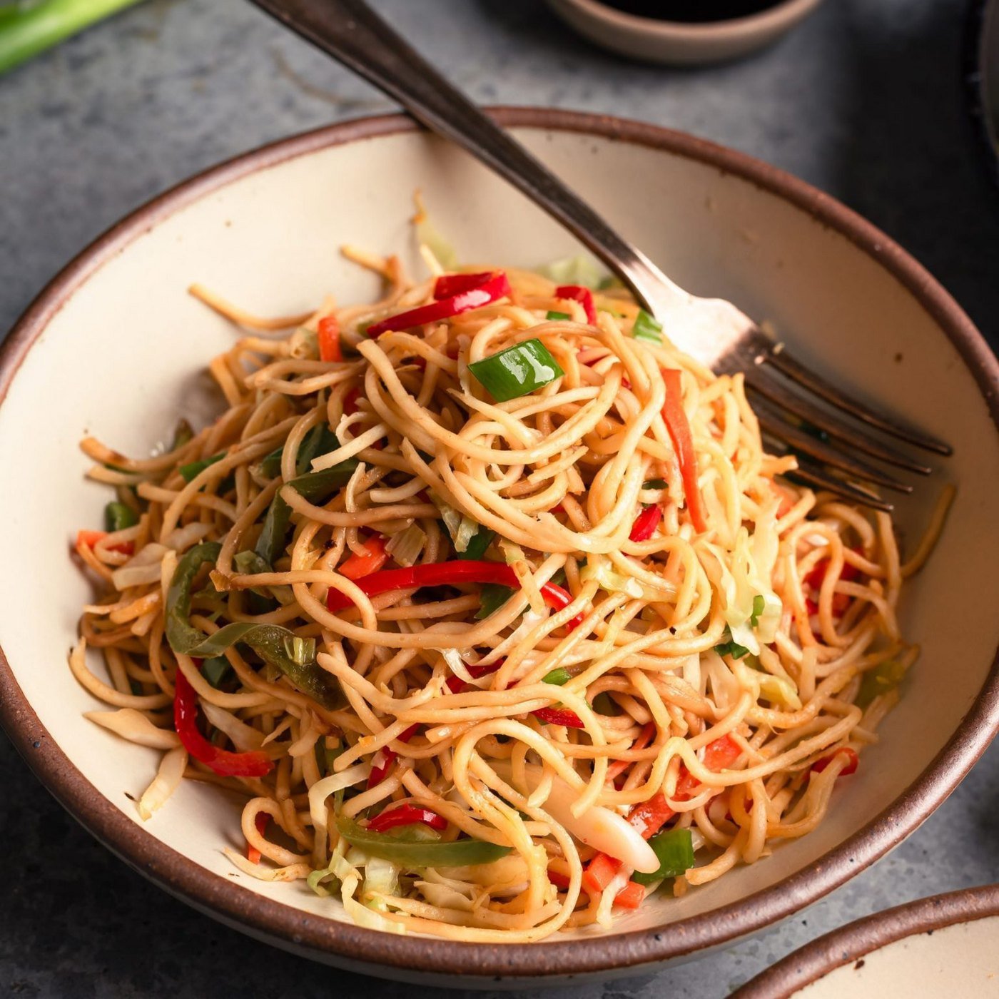 Vegetable hakka noodles tossed in a wok