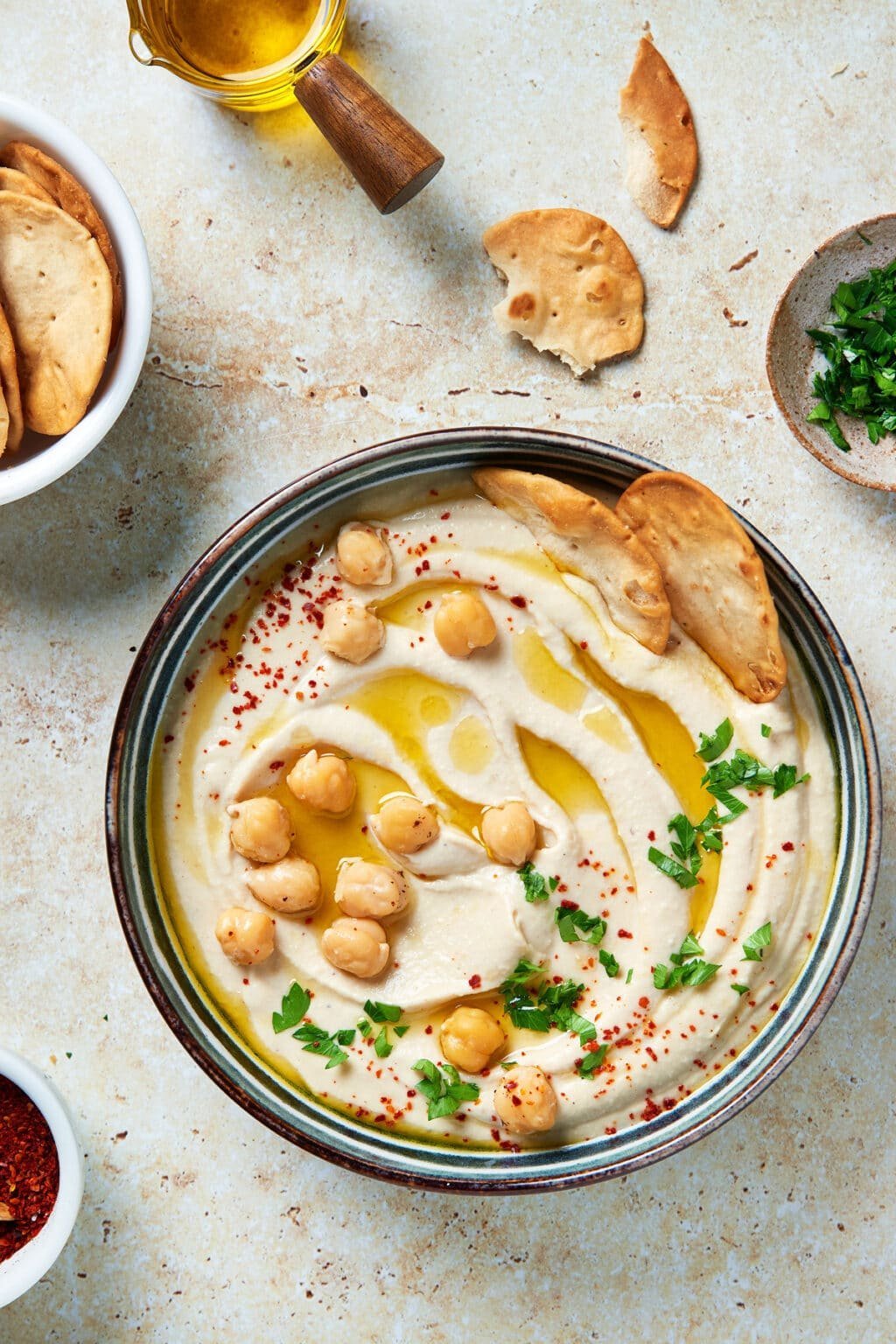 Creamy hummus with olive oil, paprika and warm pita