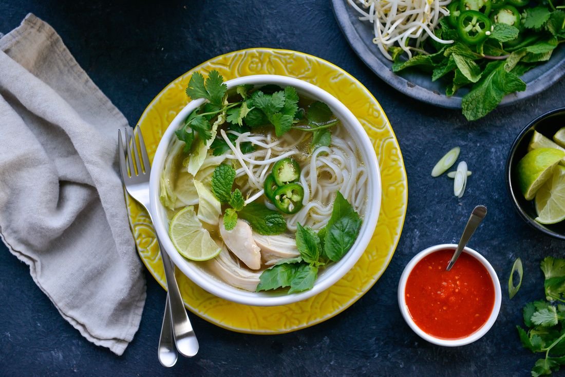 Vietnamese chicken pho with rice noodles and fresh herbs